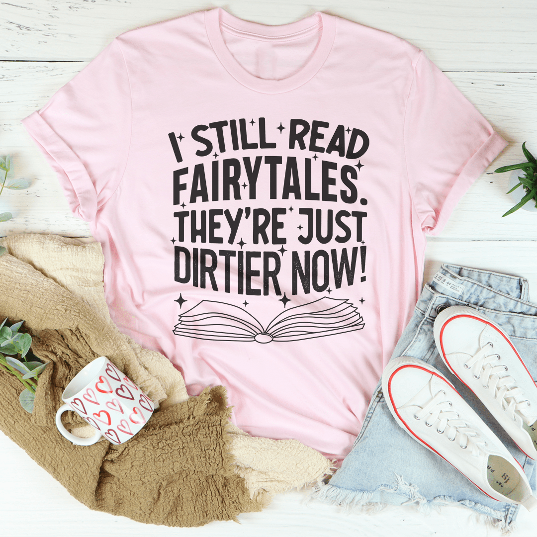 A stylish black t-shirt featuring the phrase 'I Still Read Fairytales They're Just Dirtier Now' in playful typography, showcasing its comfortable fit and quality fabric.