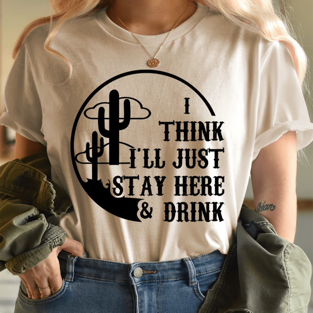 A comfortable and stylish t-shirt featuring the phrase 'I Think I'll Just Stay Here & Drink' printed on it, made from soft ring-spun cotton.