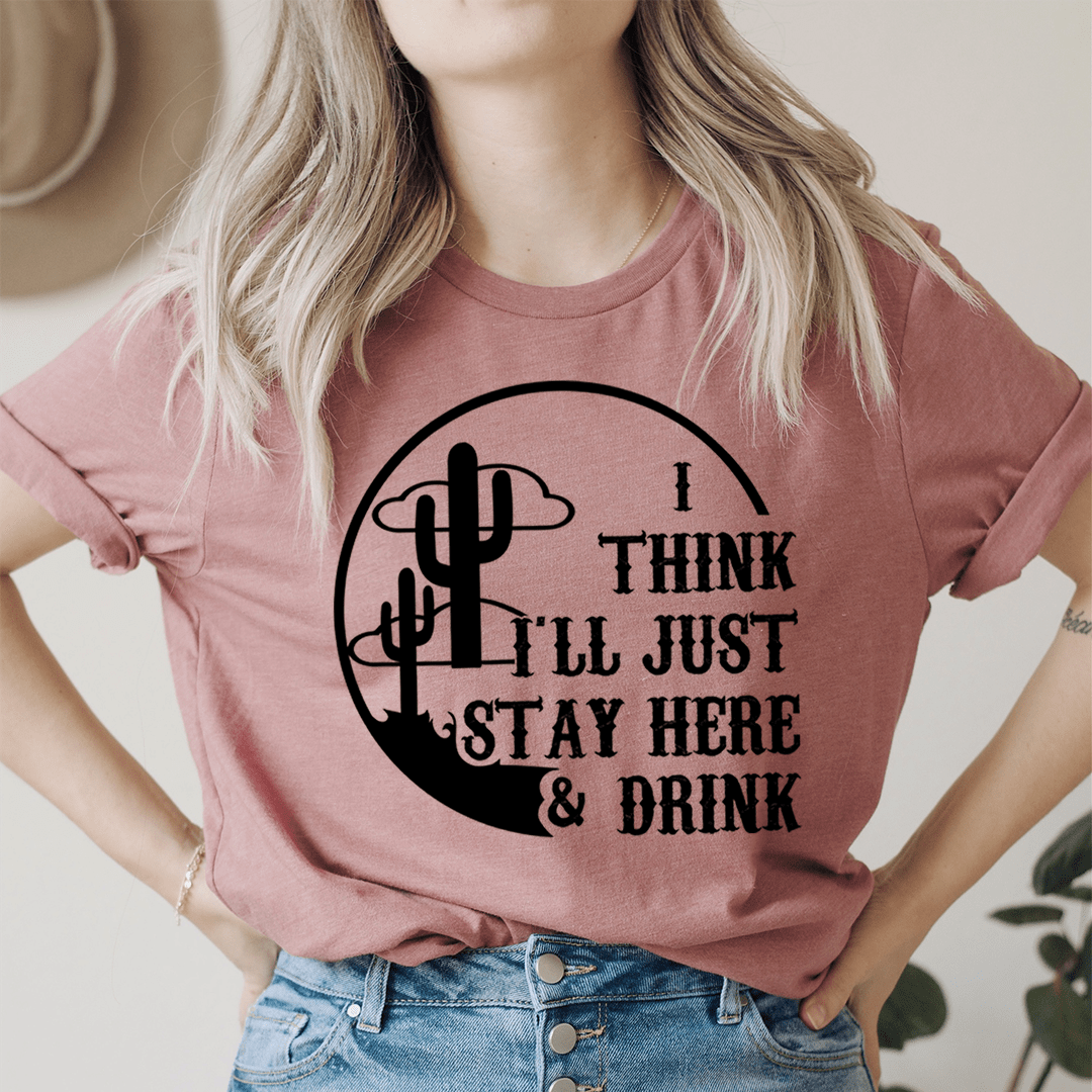 A comfortable and stylish t-shirt featuring the phrase 'I Think I'll Just Stay Here & Drink' printed on it, made from soft ring-spun cotton.