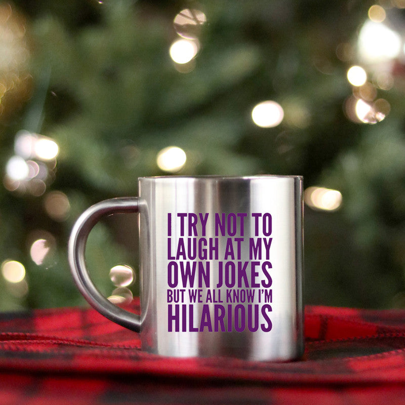 Ceramic mug with gold and silver design featuring the phrase 'I Try Not To Laugh At My Own Jokes'.