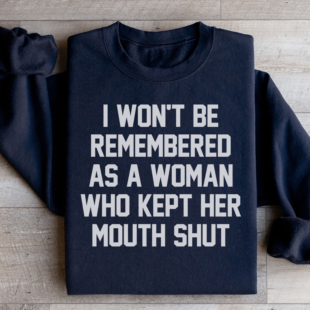 A stylish sweatshirt featuring the phrase 'I Won't Be Remembered As A Woman Who Kept Her Mouth', designed by top artists, showcasing a cozy fleece material.