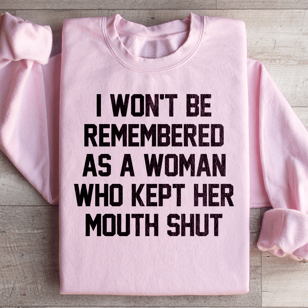 A stylish sweatshirt featuring the phrase 'I Won't Be Remembered As A Woman Who Kept Her Mouth', designed by top artists, showcasing a cozy fleece material.