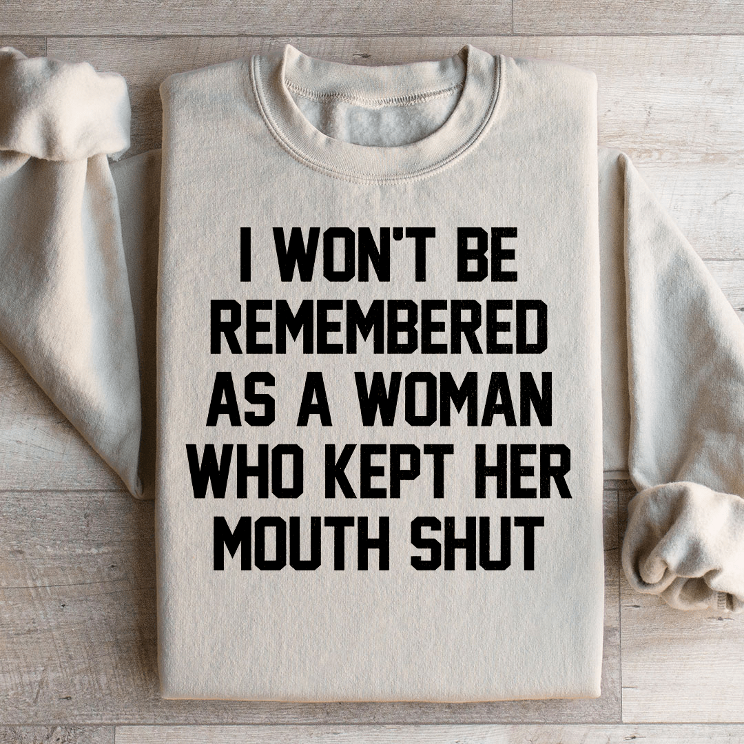 A stylish sweatshirt featuring the phrase 'I Won't Be Remembered As A Woman Who Kept Her Mouth', designed by top artists, showcasing a cozy fleece material.