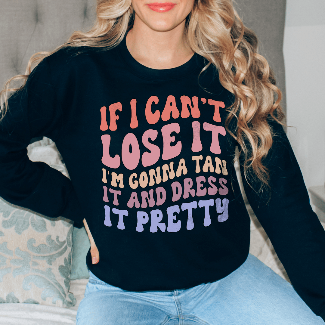 A cozy hoodie featuring the phrase 'If I Can't Lose It I'm Gonna Tan It And Dress It Pretty', designed by top artists, showcasing vibrant colors and a comfortable fit.