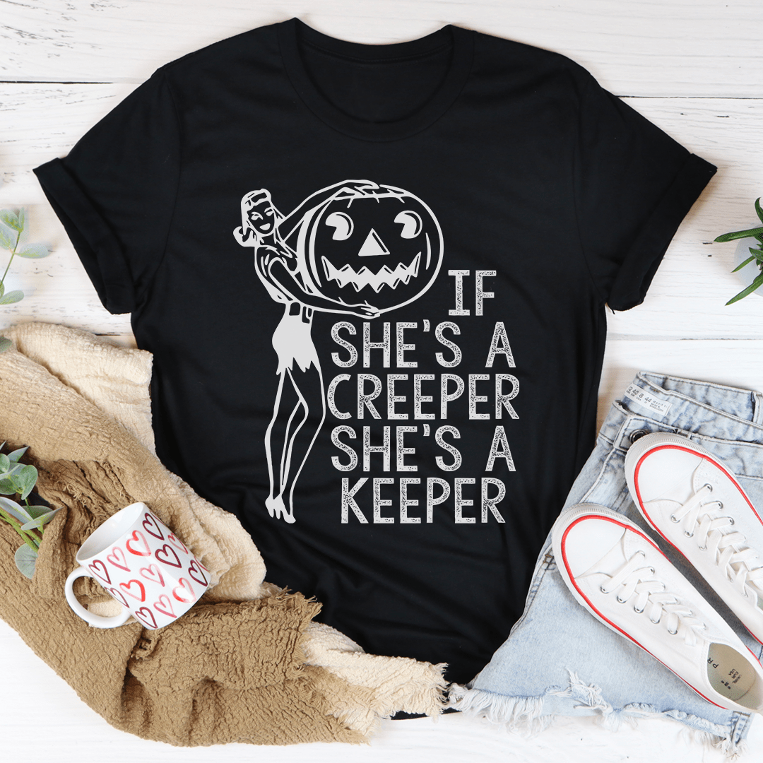 A stylish t-shirt featuring the phrase 'If She's A Creeper She's A Keeper' printed on soft cotton fabric, showcasing its durability and comfort.