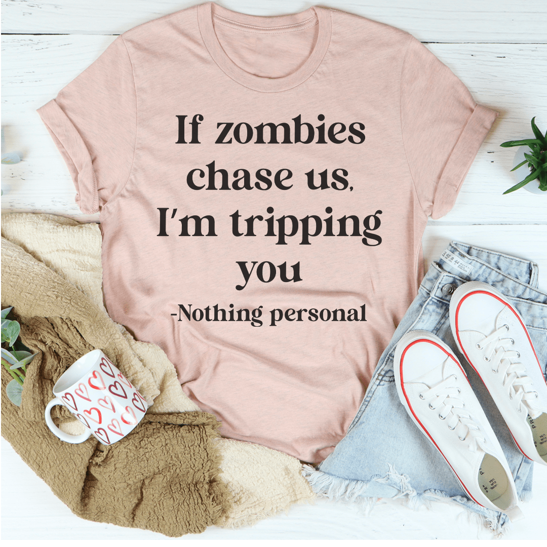 A humorous t-shirt featuring the phrase 'If Zombies Chase Us I'm Tripping You', made from soft cotton with double stitching.