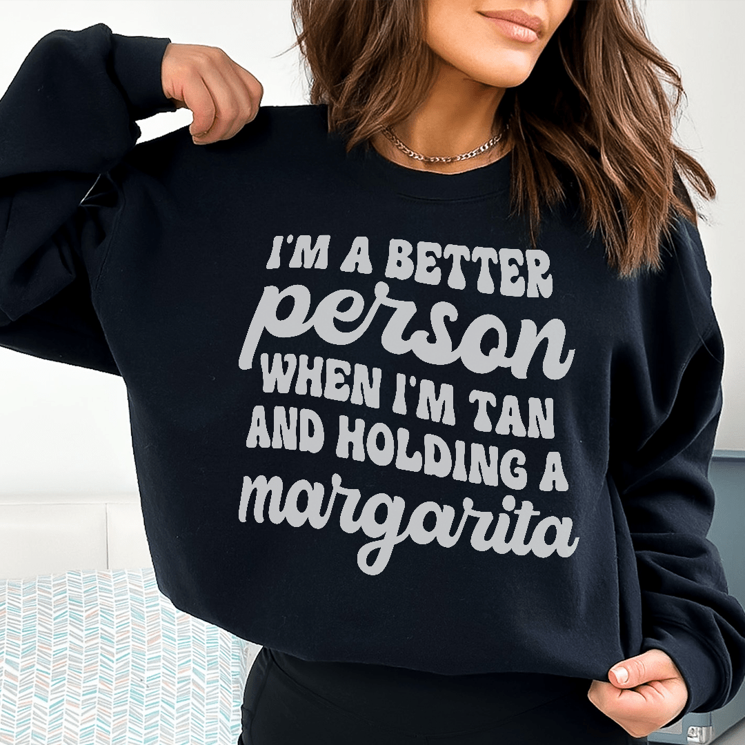 A cozy hoodie featuring the phrase 'I'm A Better Person When I'm Tan', designed by top artists, showcasing a stylish and comfortable fit.