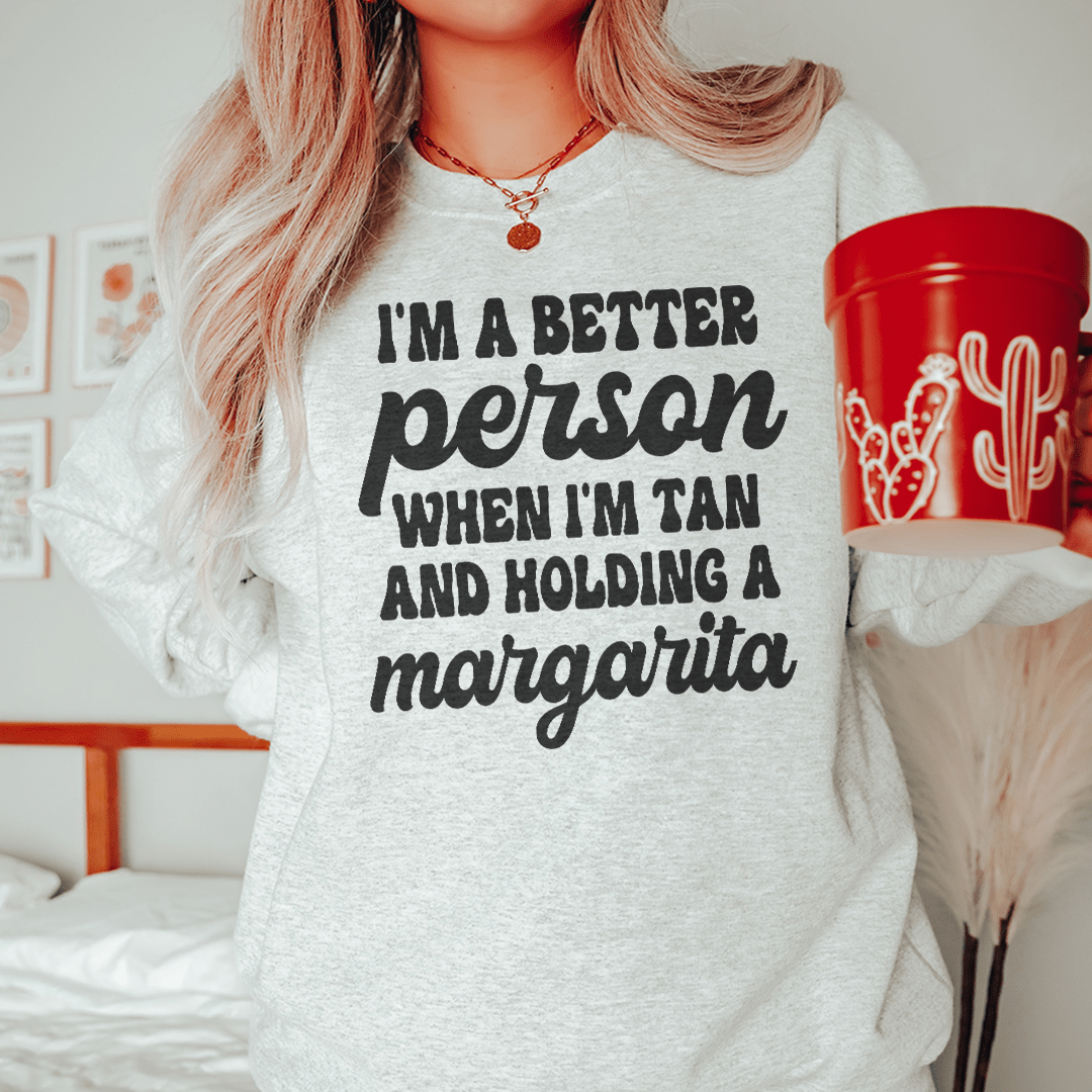 A cozy hoodie featuring the phrase 'I'm A Better Person When I'm Tan', designed by top artists, showcasing a stylish and comfortable fit.