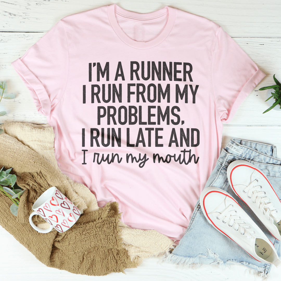 A humorous t-shirt featuring the phrase 'I'm A Runner I Run From My Problems, I Run Late And I Run My Mouth' in bold print, made from soft cotton.