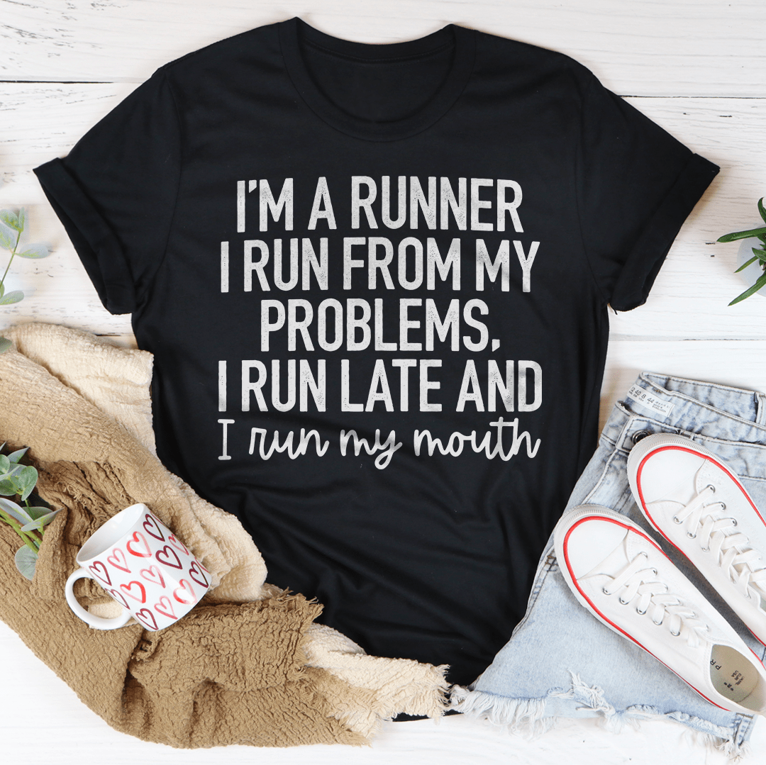 A humorous t-shirt featuring the phrase 'I'm A Runner I Run From My Problems, I Run Late And I Run My Mouth' in bold print, made from soft cotton.