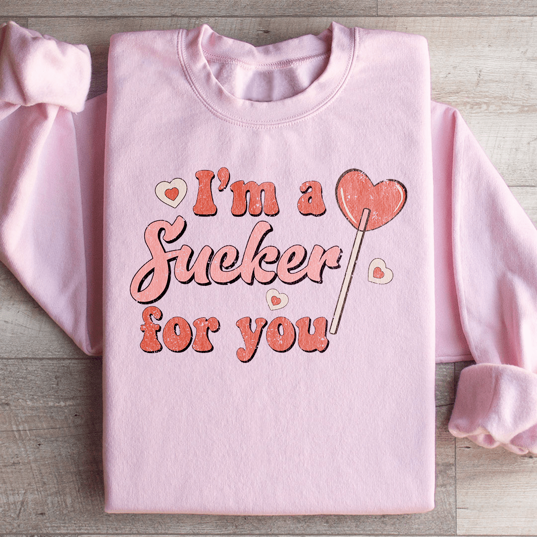 A cozy pair of 'I'm A Sucker For You' sweats featuring a unique design by top artists, made from a warm cotton/poly fleece blend.