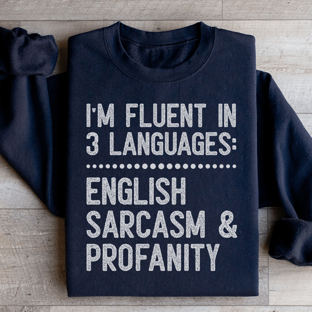 A cozy 'I'm Fluent In 3 Languages' hoodie featuring unique artistic designs, made from a soft cotton/poly fleece blend.