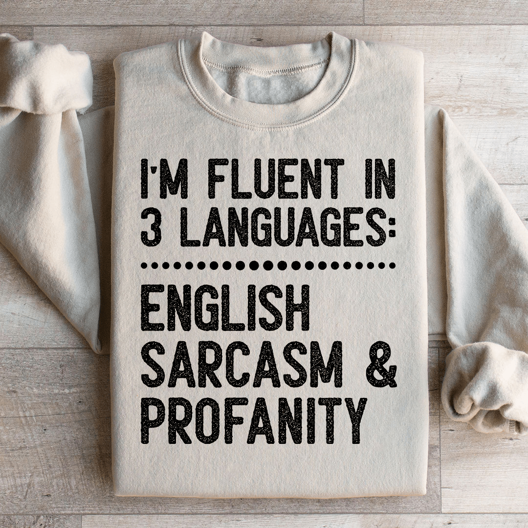 A cozy 'I'm Fluent In 3 Languages' hoodie featuring unique artistic designs, made from a soft cotton/poly fleece blend.