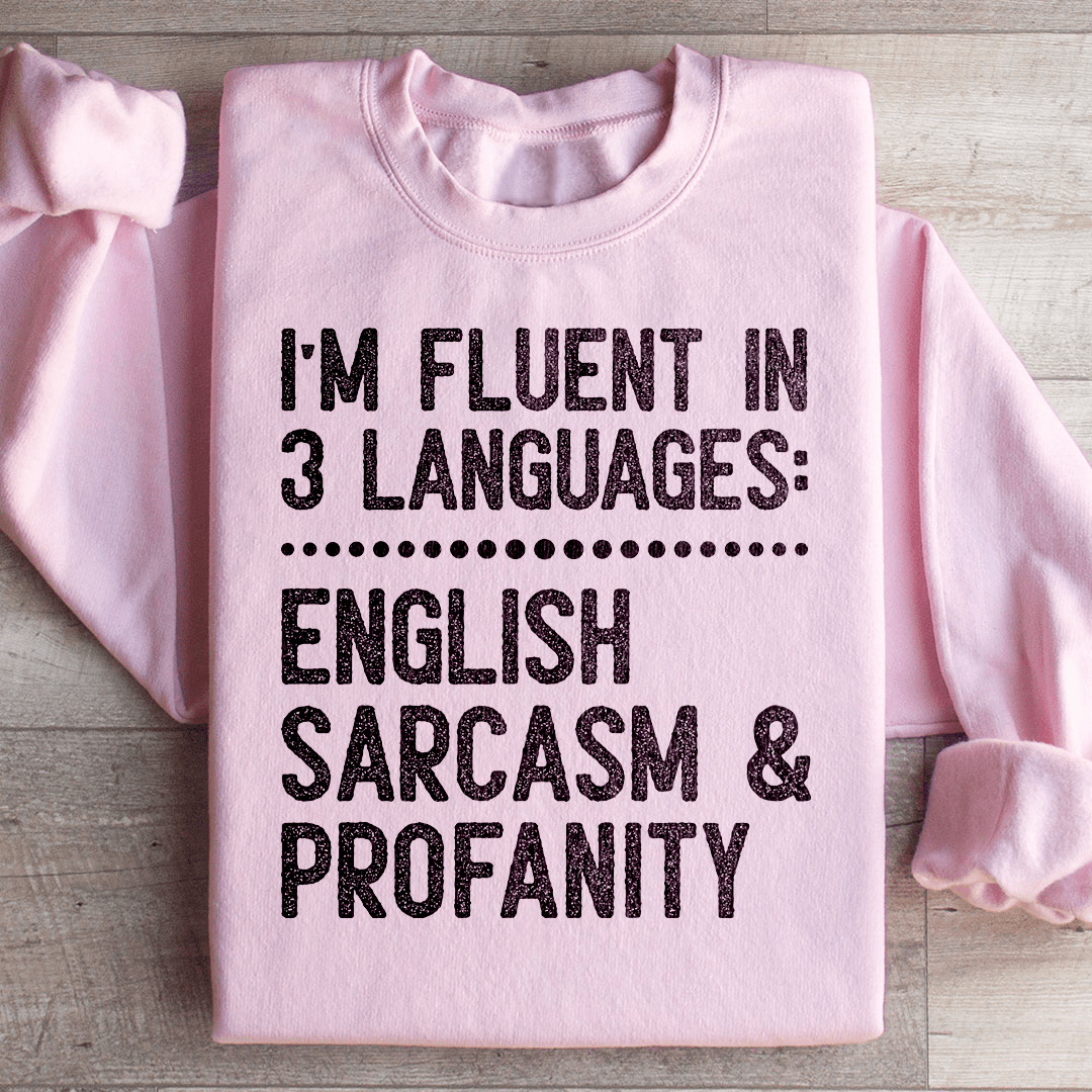 A cozy 'I'm Fluent In 3 Languages' hoodie featuring unique artistic designs, made from a soft cotton/poly fleece blend.