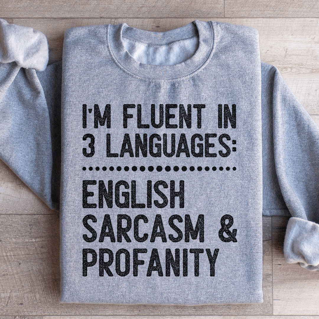 A cozy 'I'm Fluent In 3 Languages' hoodie featuring unique artistic designs, made from a soft cotton/poly fleece blend.