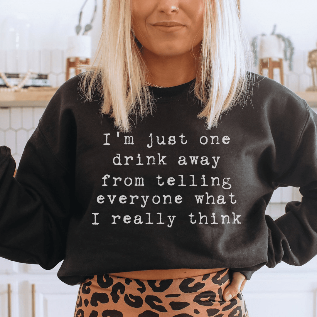 A cozy hoodie featuring the phrase 'I'm Just One Drink Away', designed by top artists, showcasing unique artwork and a comfortable fit.