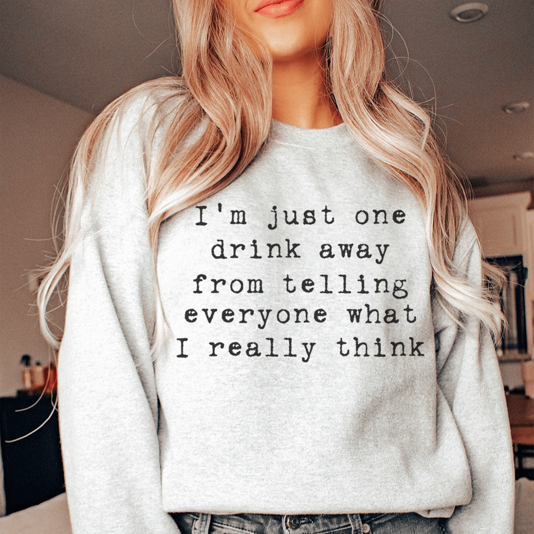 A cozy hoodie featuring the phrase 'I'm Just One Drink Away', designed by top artists, showcasing unique artwork and a comfortable fit.