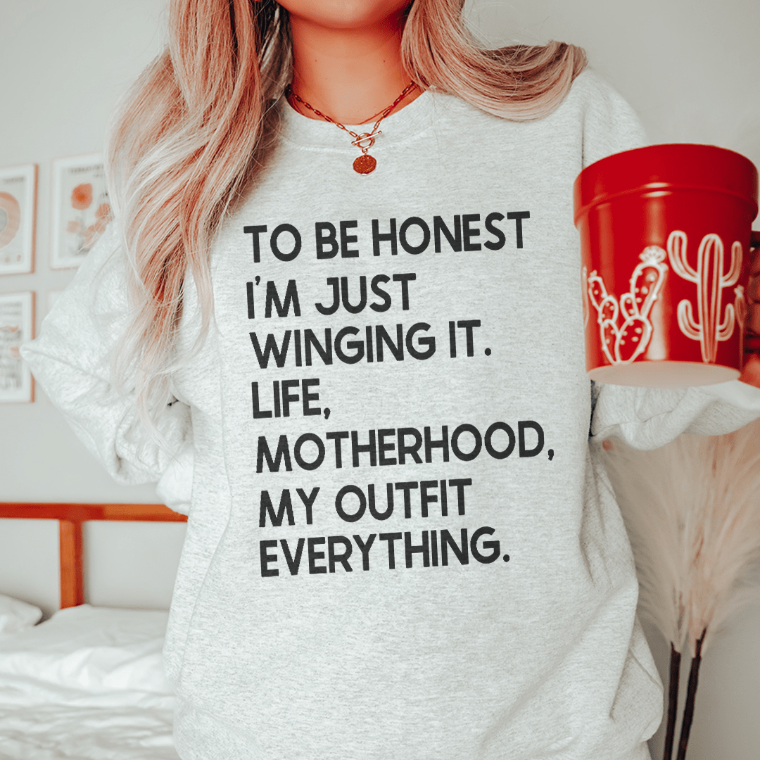 A cozy pair of 'I'm Just Winging It' sweats featuring unique artistic designs, made from a soft cotton/poly fleece blend.