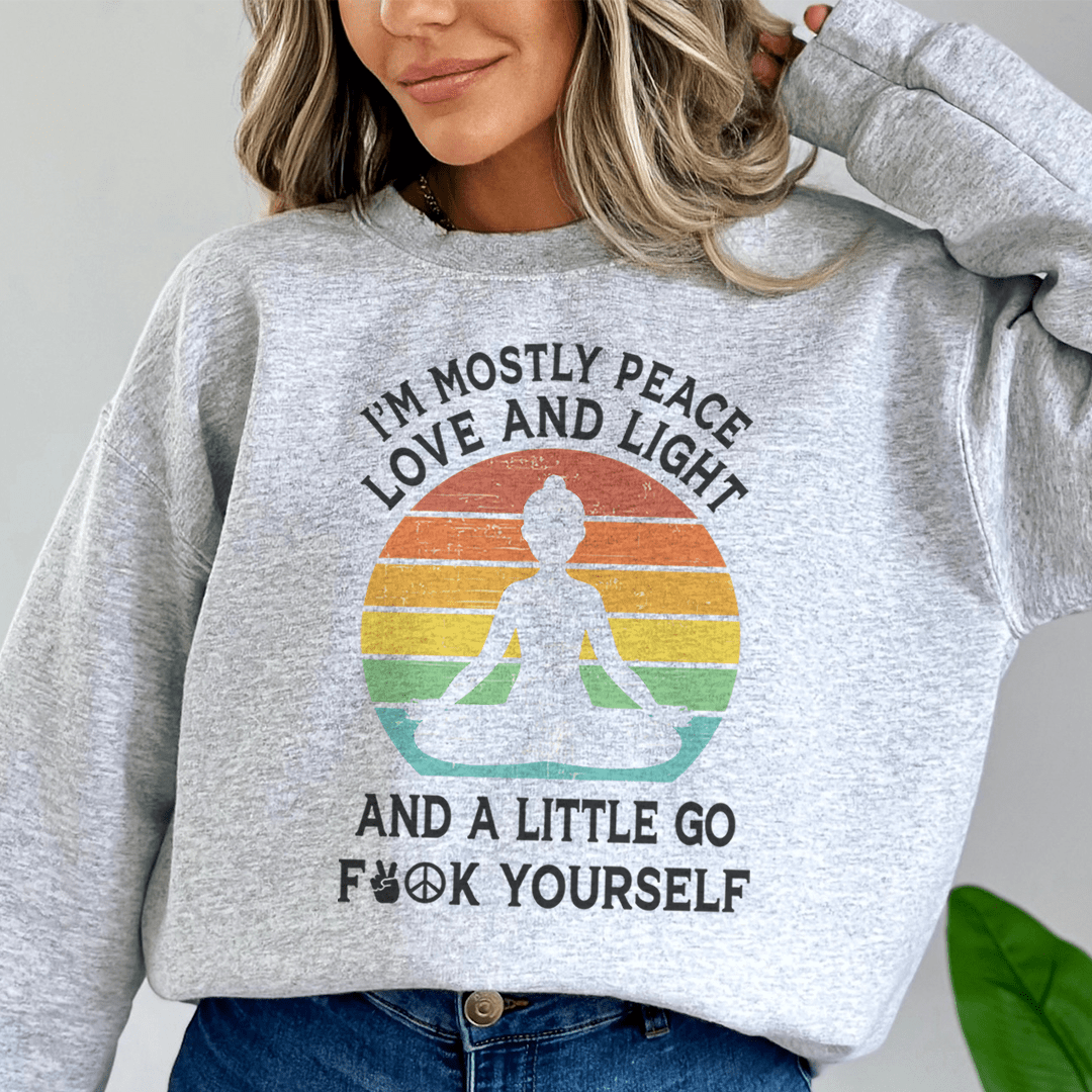 A cozy hoodie featuring the phrase 'I'm Mostly Peace Love And Light' designed by top artists, showcasing vibrant colors and a comfortable fit.