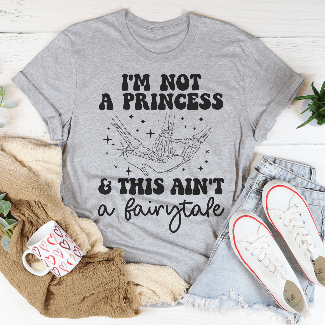 A stylish black t-shirt with the phrase 'I'm Not A Princess & This Ain't A Fairytale' printed in bold white letters, showcasing its comfortable fit and quality fabric.