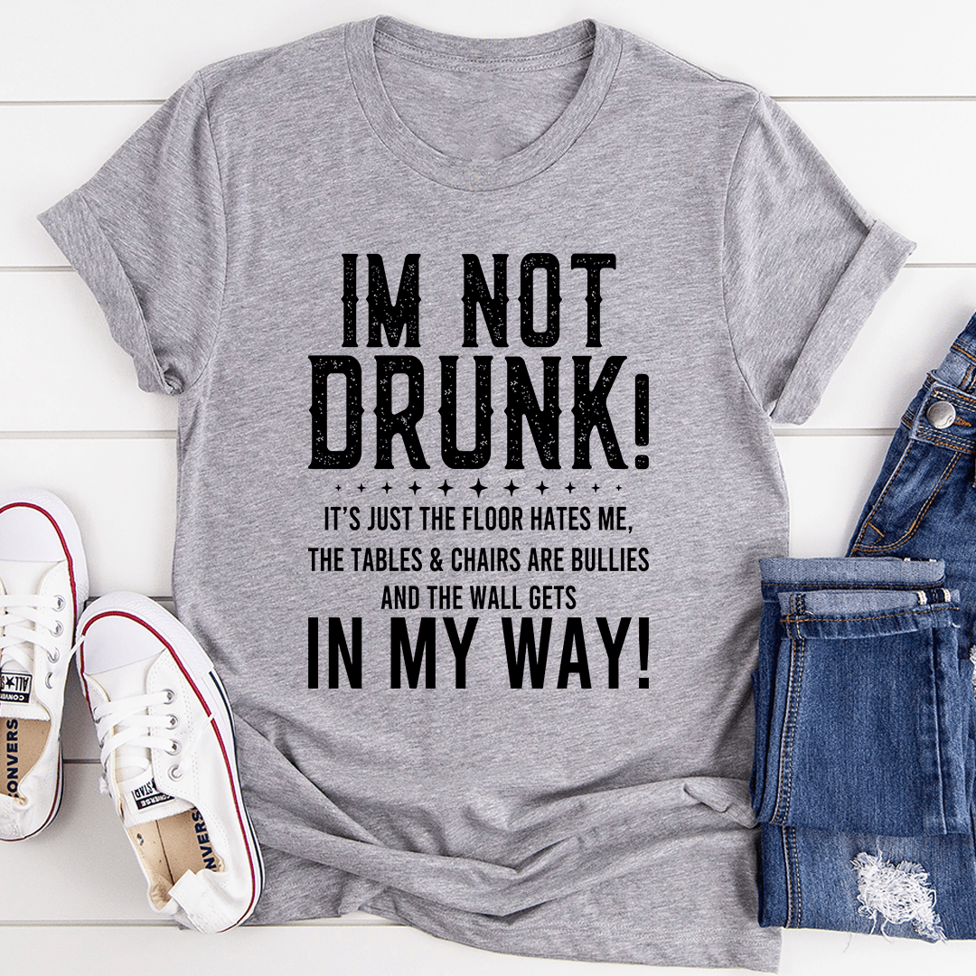 A black t-shirt with the text 'I'm Not Drunk' printed in bold white letters, showcasing a casual and humorous style.