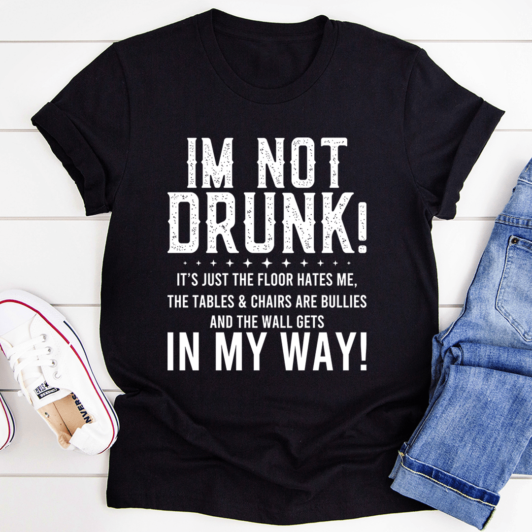 A black t-shirt with the text 'I'm Not Drunk' printed in bold white letters, showcasing a casual and humorous style.