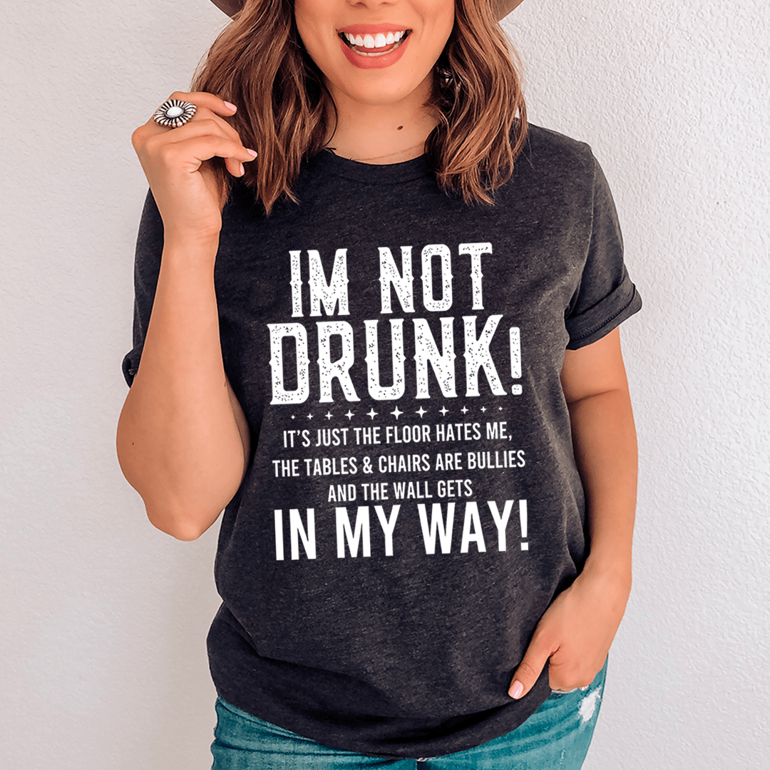 A black t-shirt with the text 'I'm Not Drunk' printed in bold white letters, showcasing a casual and humorous style.