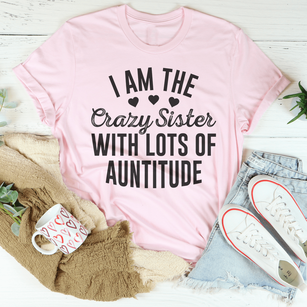 I'm The Crazy Sister With Lots Of Auntitude Tee, featuring a playful design on a soft cotton fabric, perfect for casual wear.