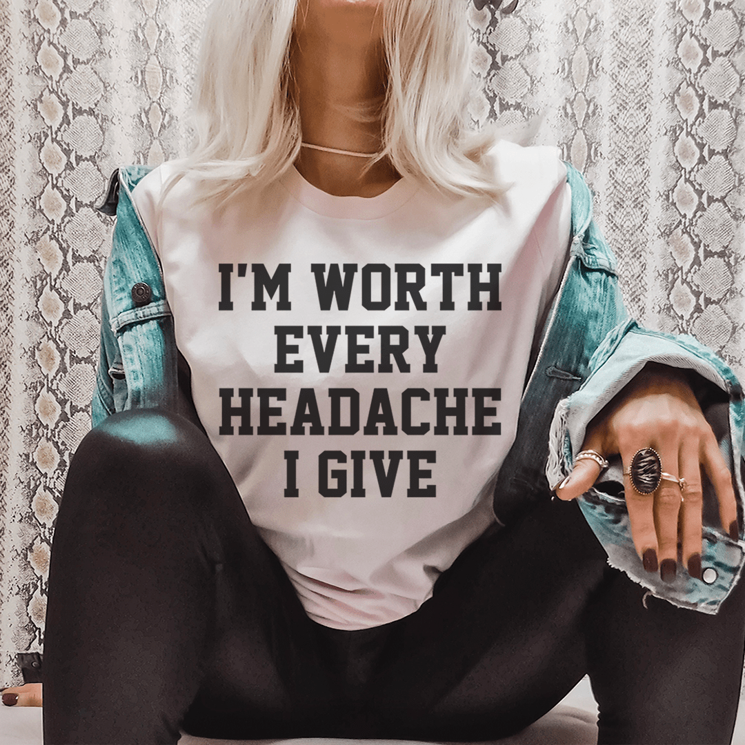 A stylish black t-shirt featuring the phrase 'I'm Worth Every Headache I Give' in bold lettering, showcasing its soft fabric and durable stitching.