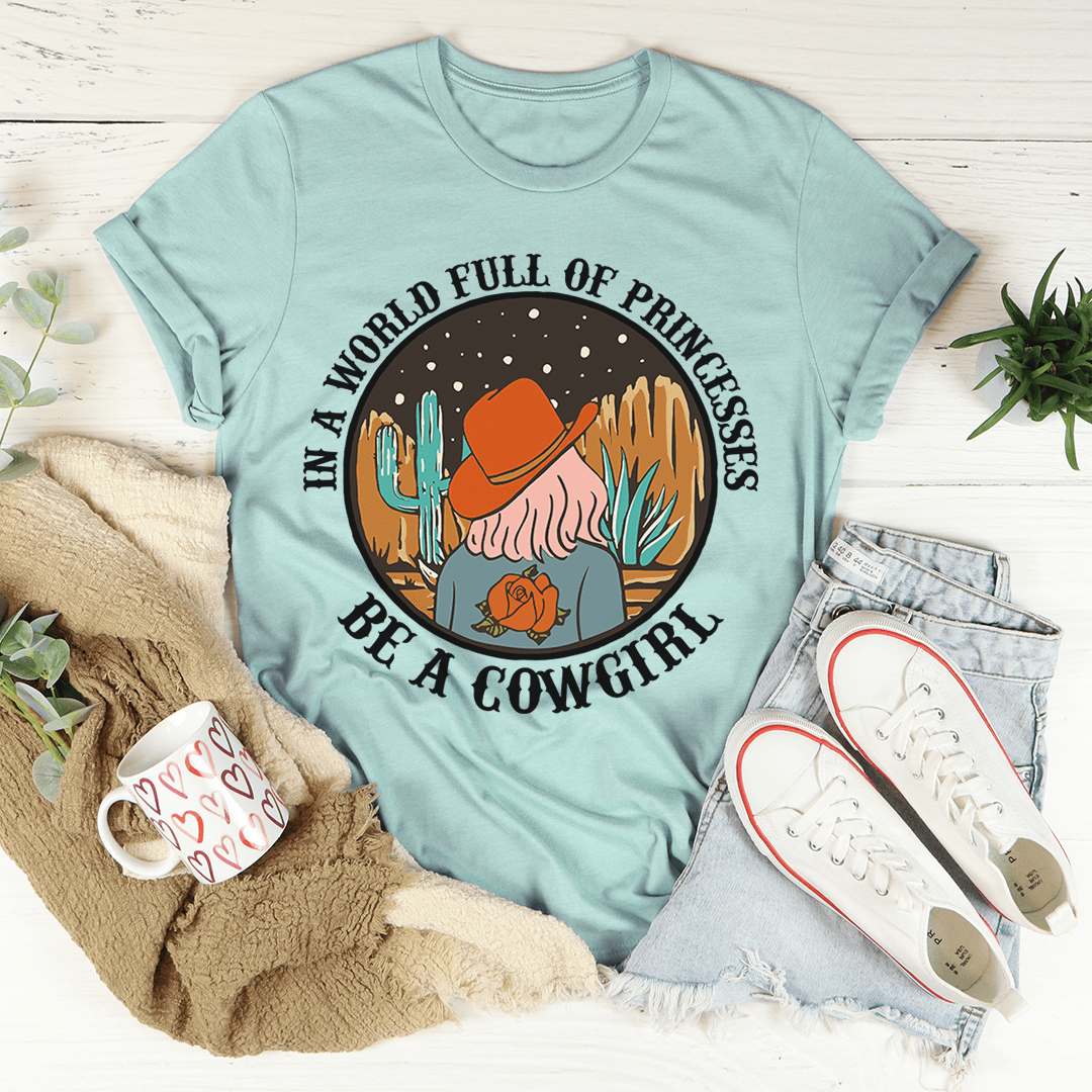 A stylish cowgirl-themed t-shirt featuring the phrase 'In A World Full Of Princesses Be A Cowgirl', made from soft cotton.