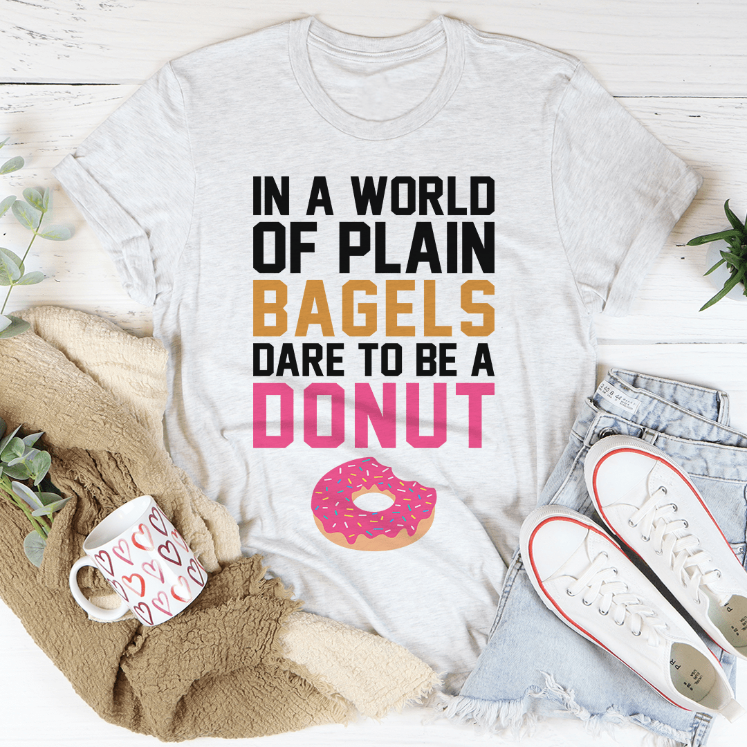 In A World Of Plain Bagels Tee, a soft cotton t-shirt with double stitching, available in various sizes.