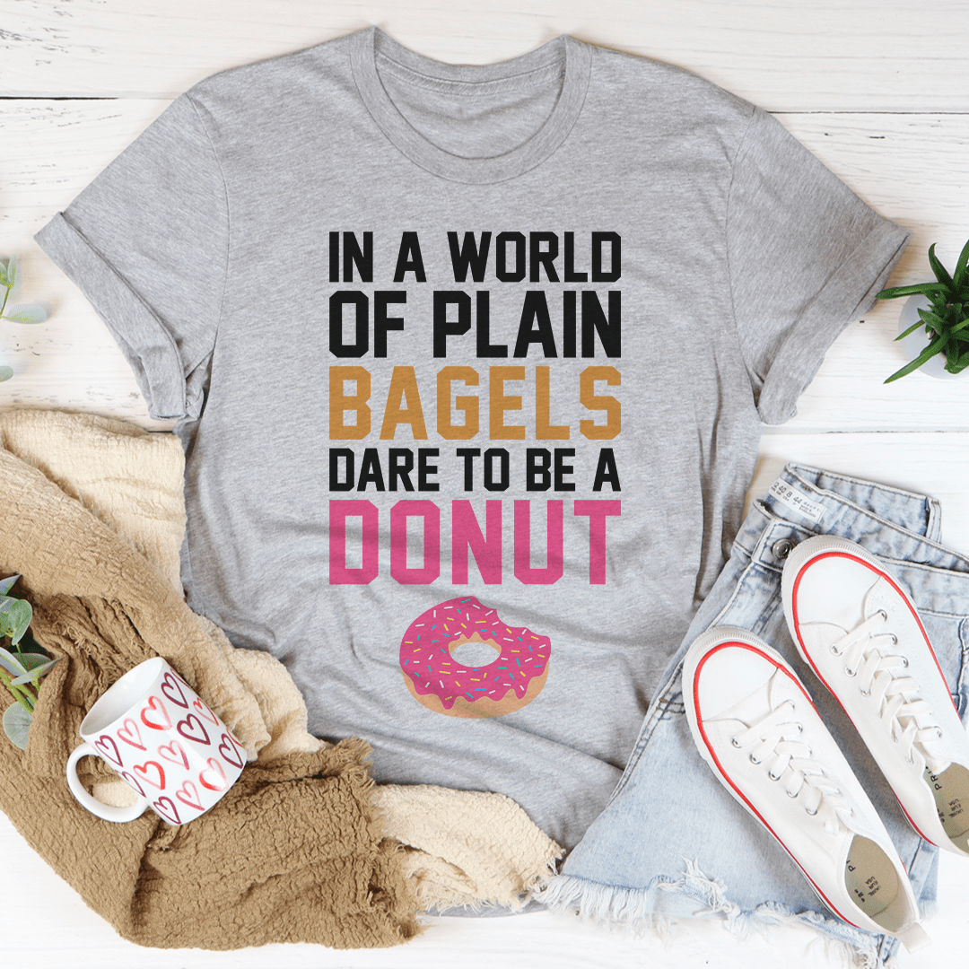 In A World Of Plain Bagels Tee, a soft cotton t-shirt with double stitching, available in various sizes.