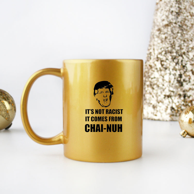 Ceramic gold and silver mug with unique design, featuring the phrase 'It’s Not Racist It Comes From Chai Nuh'.