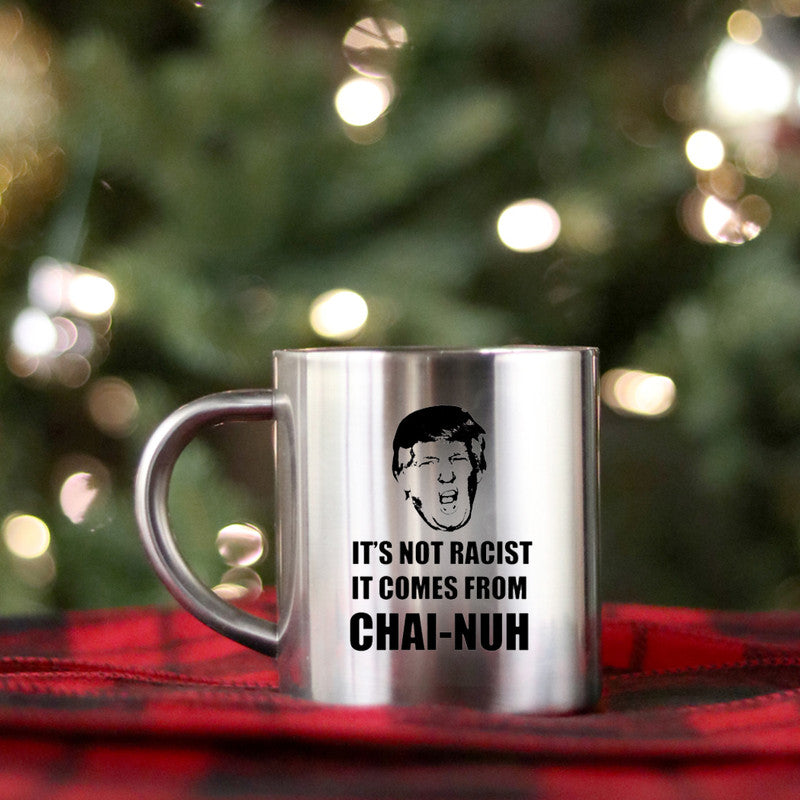 Ceramic gold and silver mug with unique design, featuring the phrase 'It’s Not Racist It Comes From Chai Nuh'.