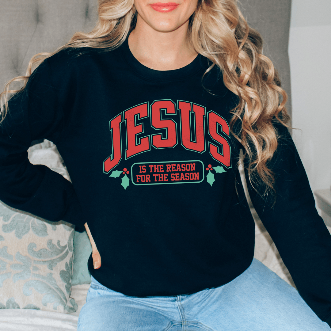 A cozy hoodie featuring the phrase 'Jesus Is The Reason For The Season', made from a warm cotton/poly fleece blend.