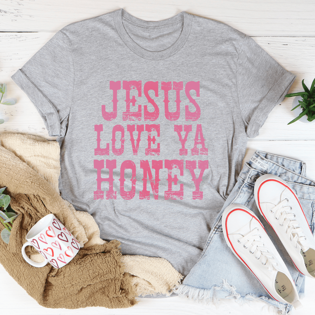 A soft and durable Jesus Love Ya Honey Tee in various colors, showcasing its comfortable fabric and stylish design.