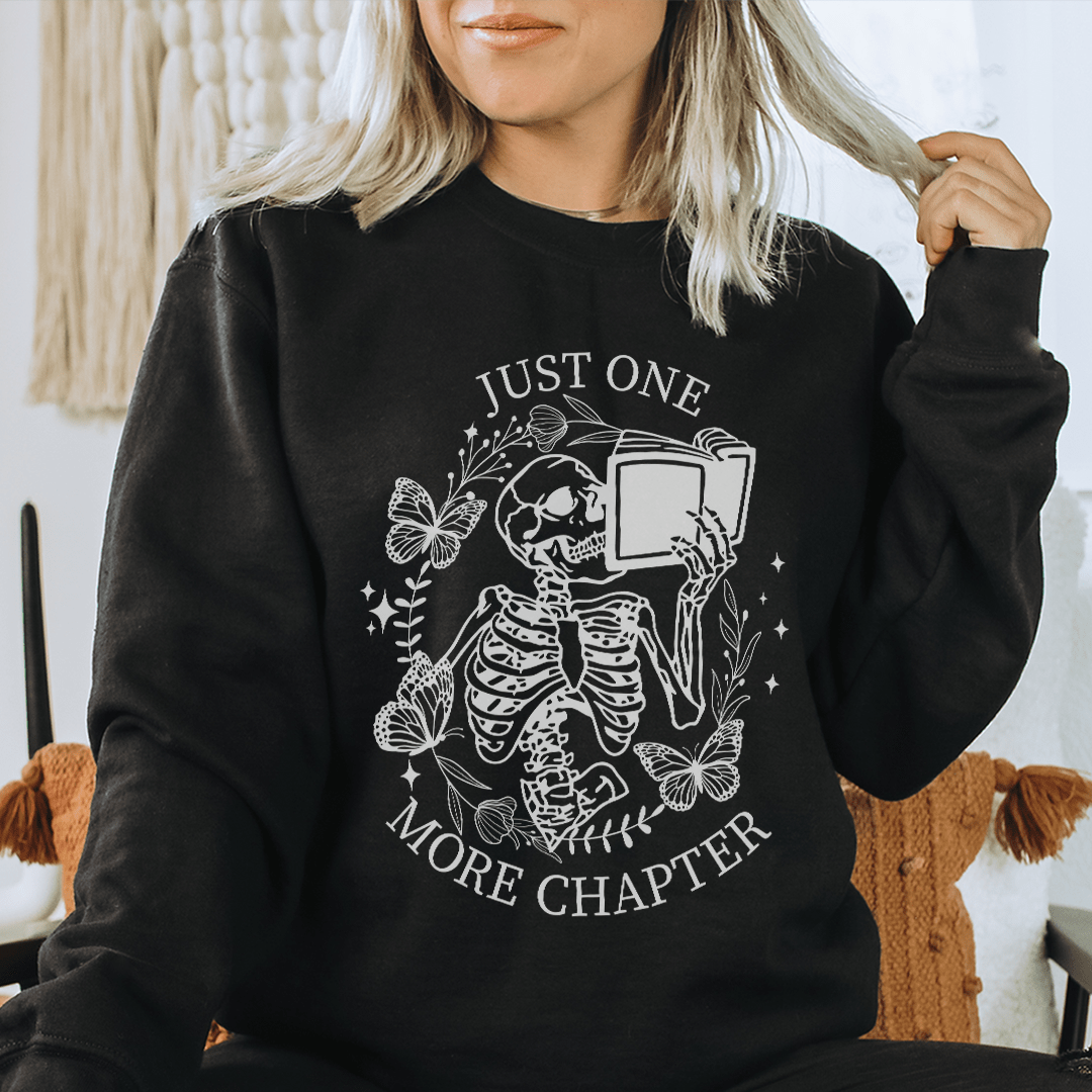 Cozy Just One More Chapter sweatshirt featuring unique designs by top artists, perfect for book lovers.