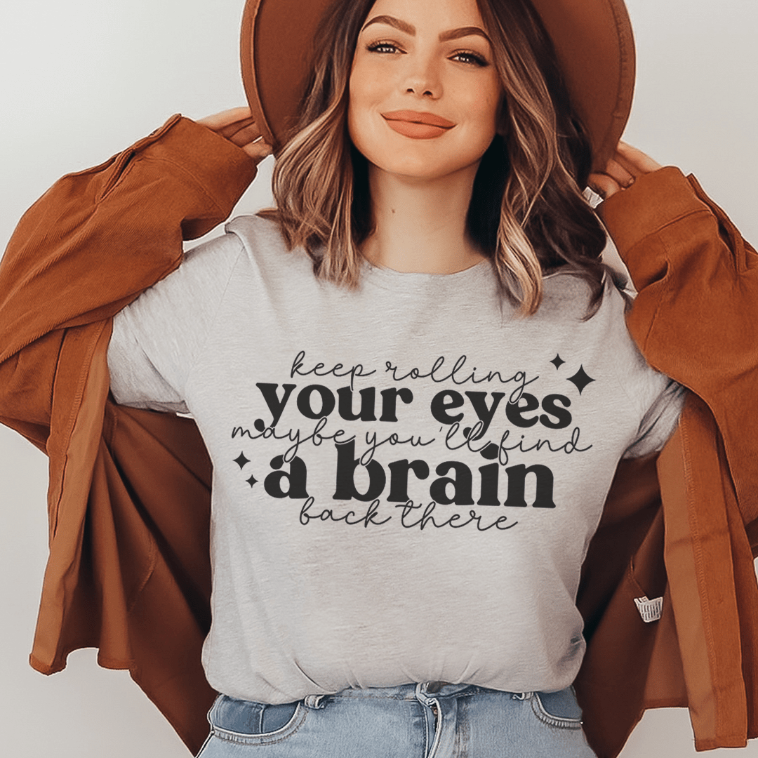 A stylish Keep Rolling Your Eyes Tee made from soft ring-spun cotton, featuring a humorous phrase and durable double stitching.