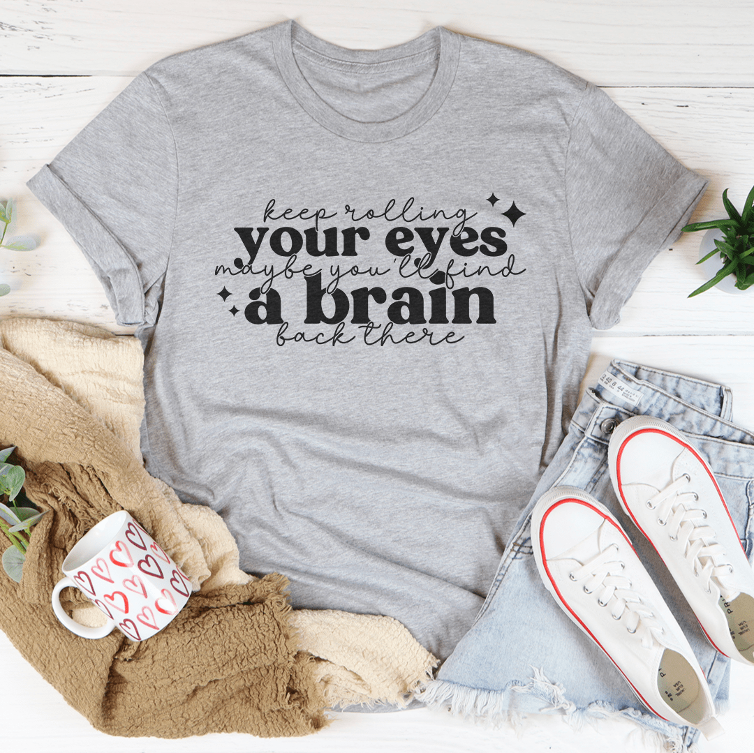 A stylish Keep Rolling Your Eyes Tee made from soft ring-spun cotton, featuring a humorous phrase and durable double stitching.