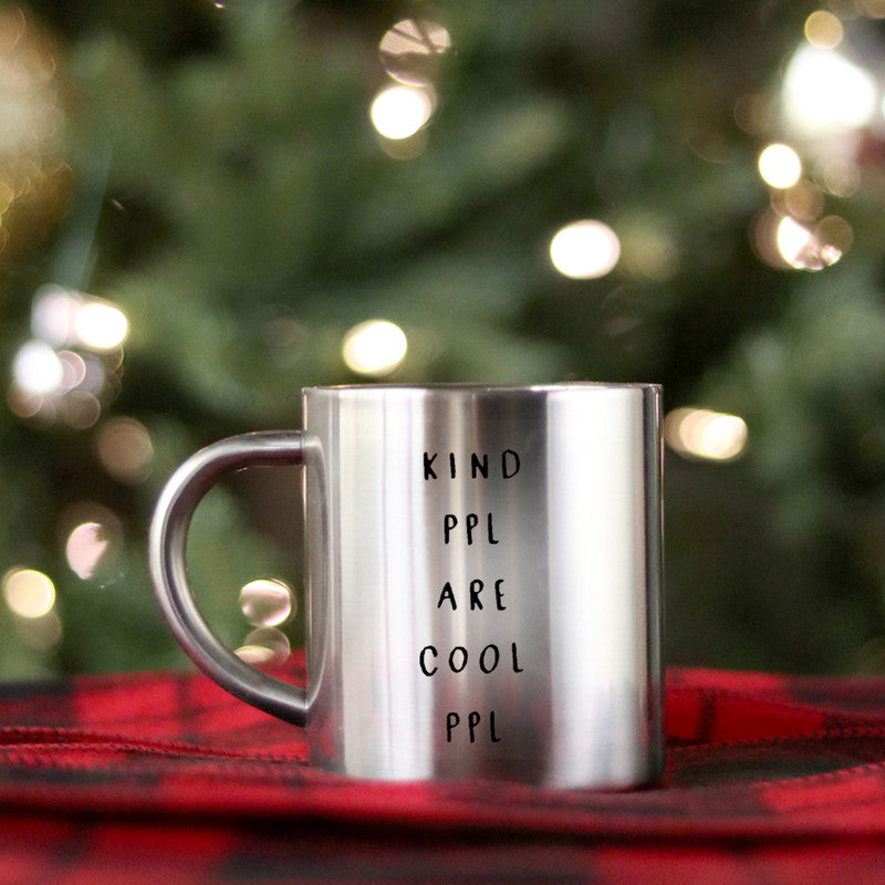 A stylish gold and silver ceramic mug with the phrase 'Kind People Are Cool People' elegantly displayed.