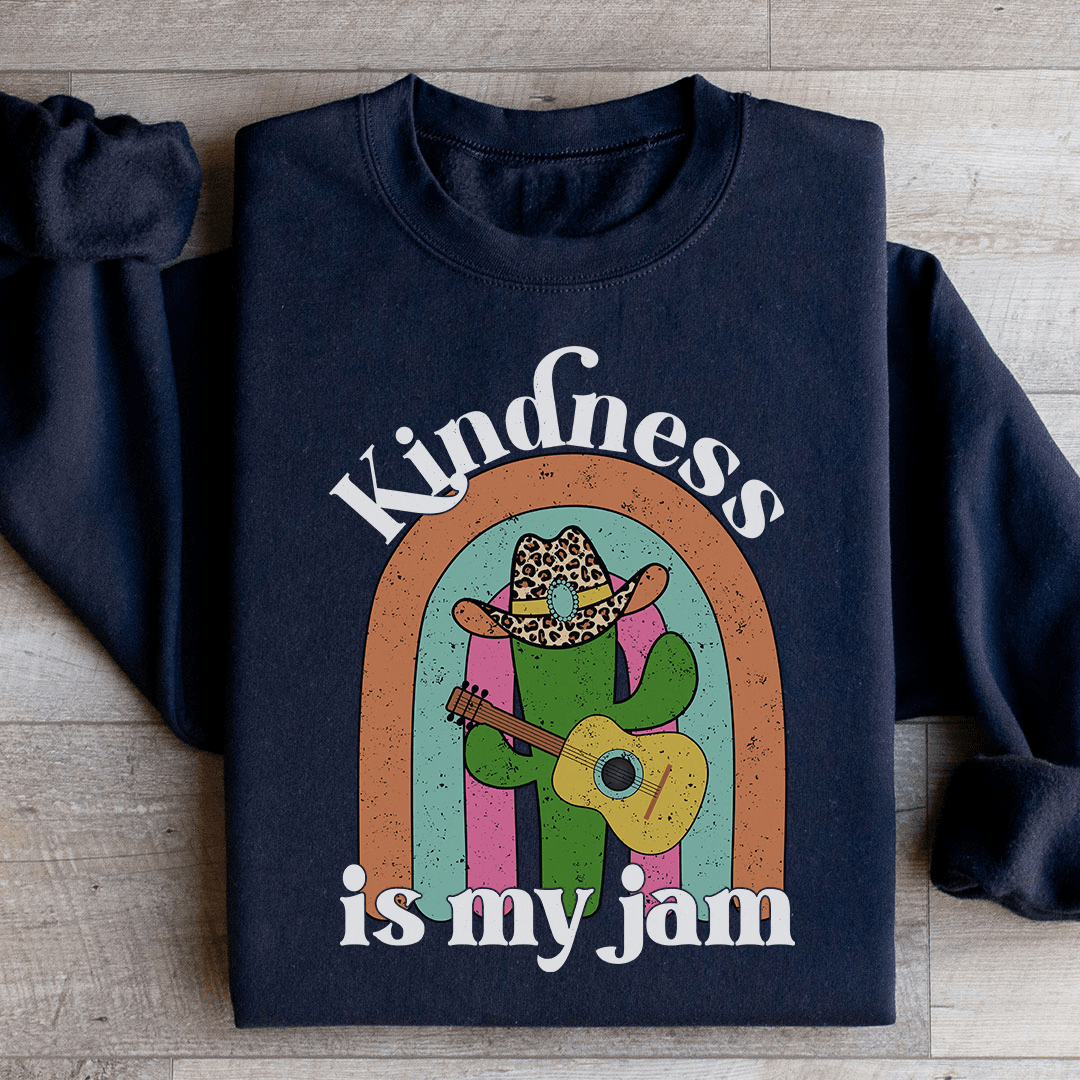 A cozy 'Kindness Is My Jam' sweatshirt featuring a unique artistic design, made from a soft cotton/poly fleece blend.