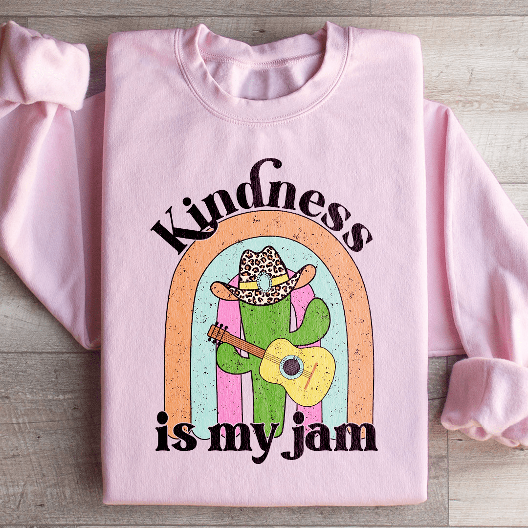 A cozy 'Kindness Is My Jam' sweatshirt featuring a unique artistic design, made from a soft cotton/poly fleece blend.