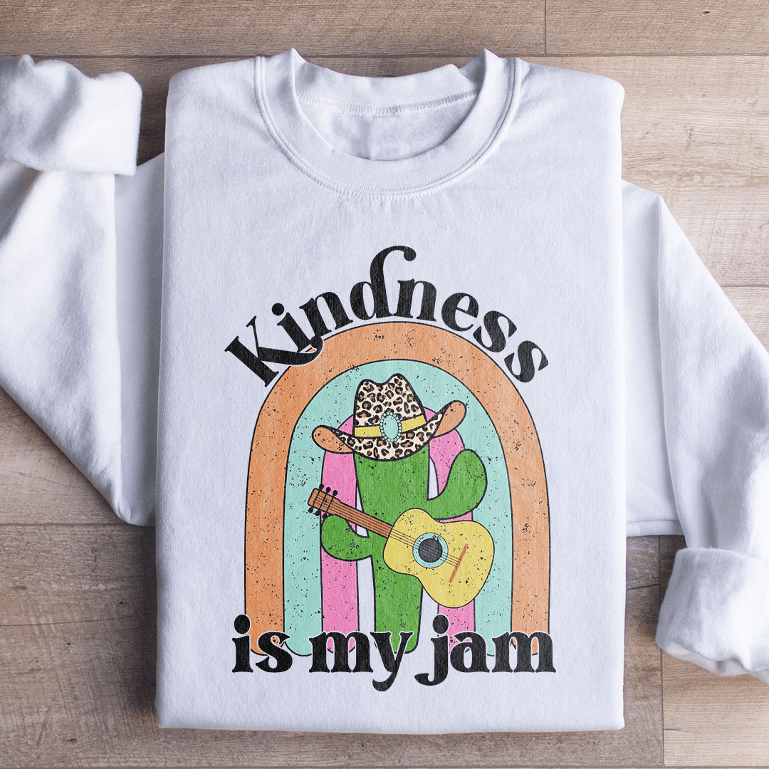 A cozy 'Kindness Is My Jam' sweatshirt featuring a unique artistic design, made from a soft cotton/poly fleece blend.