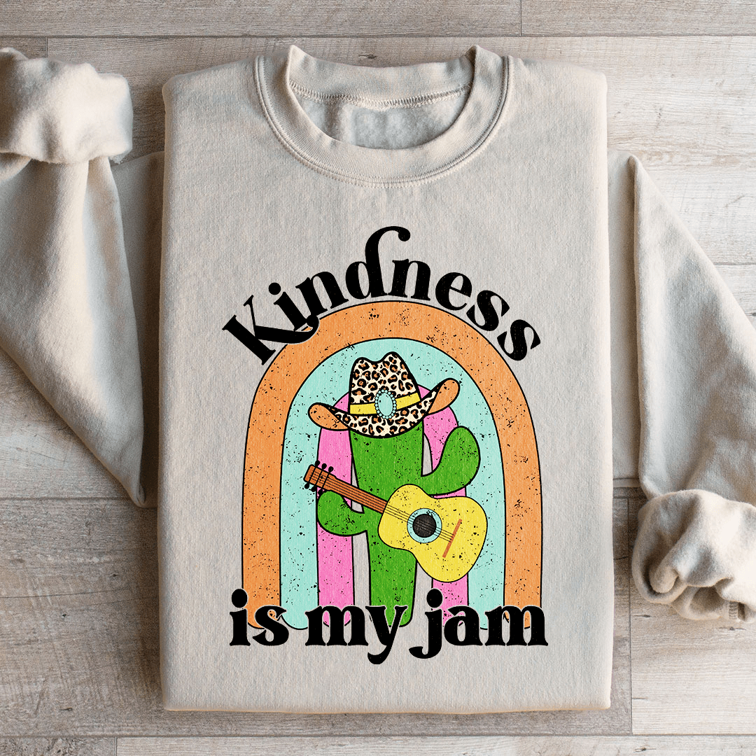 A cozy 'Kindness Is My Jam' sweatshirt featuring a unique artistic design, made from a soft cotton/poly fleece blend.