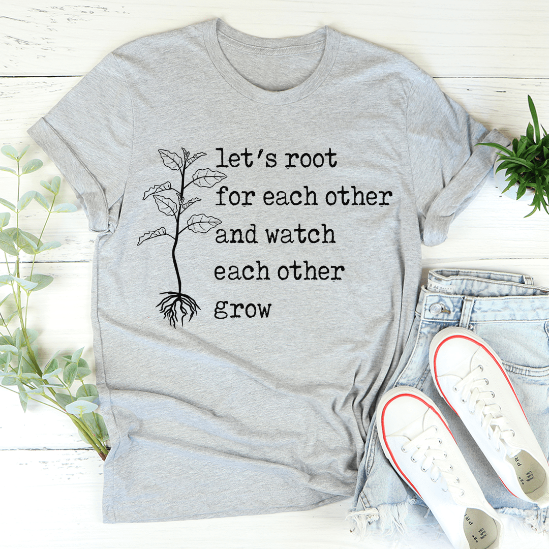 A soft, durable Let's Root For Each Other T-Shirt in various colors, featuring double stitching and a positive message.