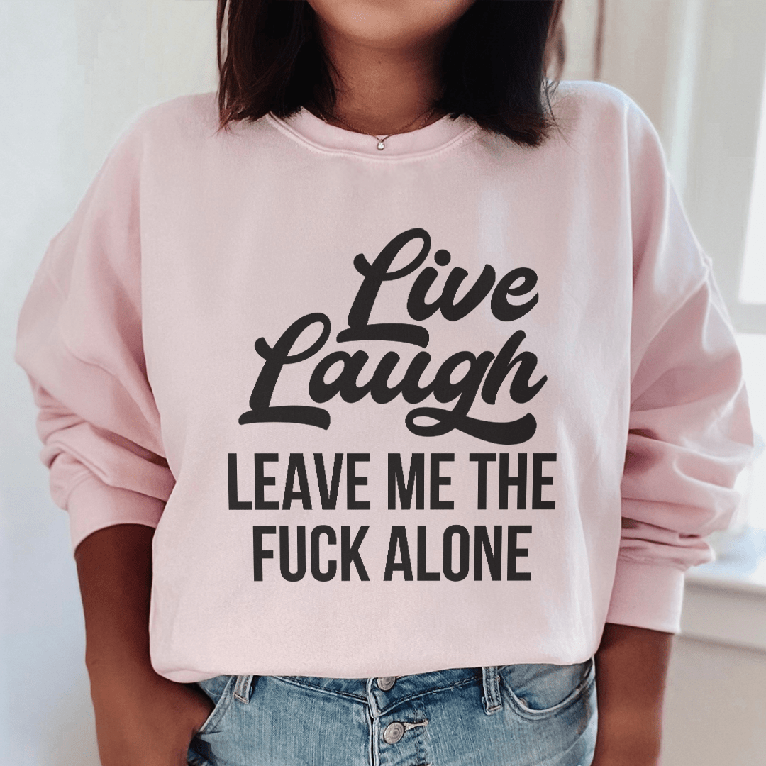 A cozy 'Live Laugh Leave Me Alone' hoodie featuring a unique design, perfect for casual wear.