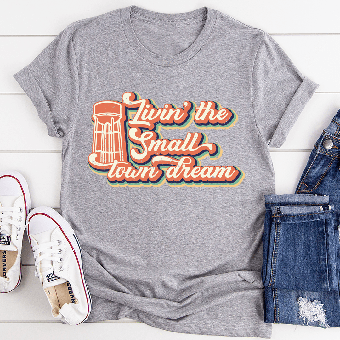 A comfortable and stylish Livin' The Small Town Dream Tee made from soft ring-spun cotton, featuring double stitching for durability.