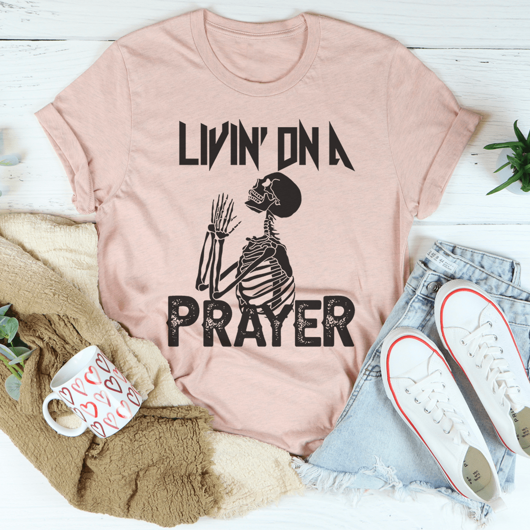 Living On A Prayer Skeleton Tee featuring a unique skeleton design on a soft cotton fabric.