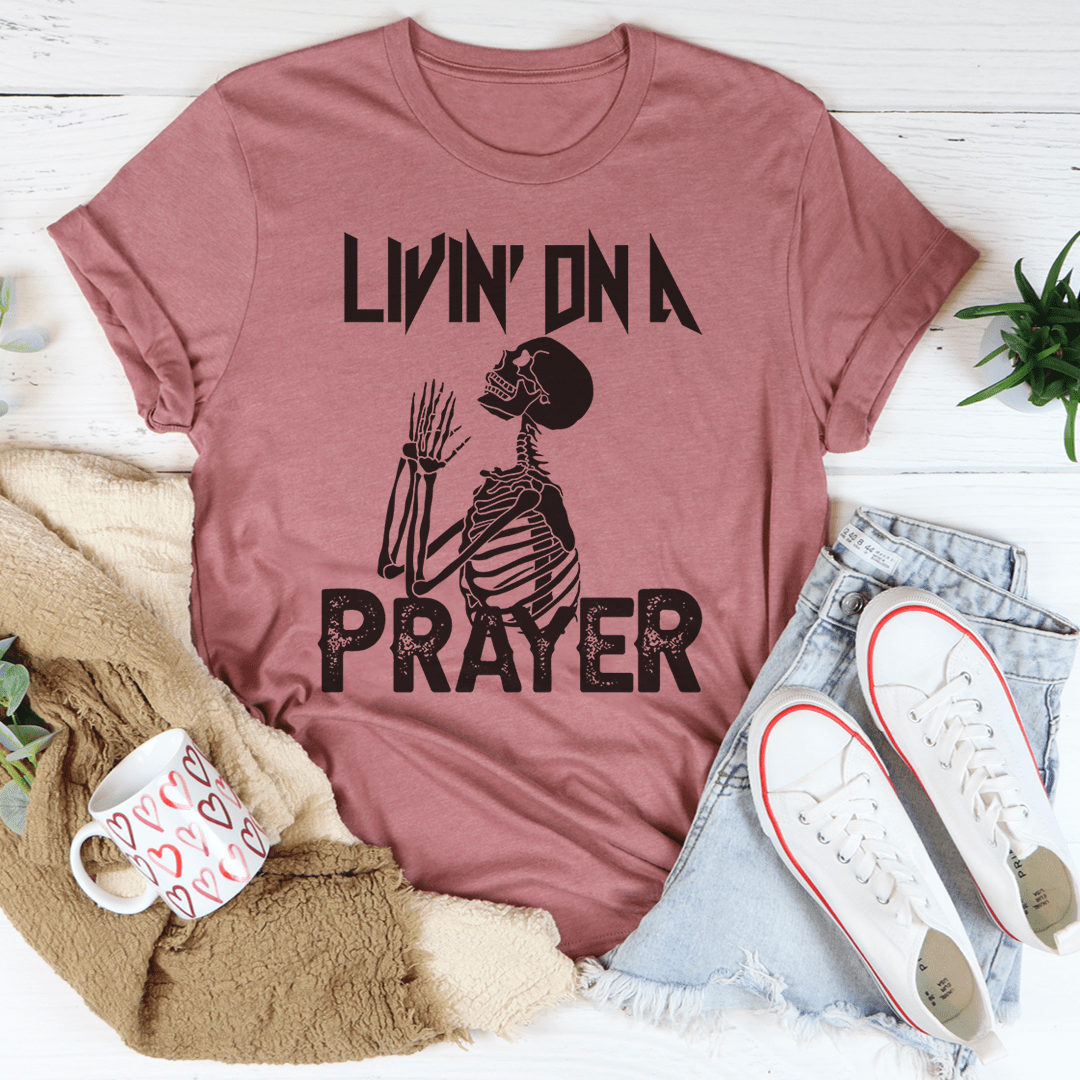 Living On A Prayer Skeleton Tee featuring a unique skeleton design on a soft cotton fabric.