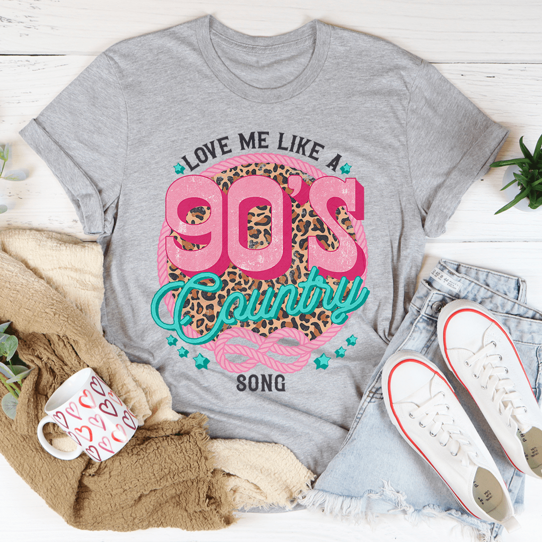 A stylish Love Me Like A 90's Country Song T-Shirt made of soft cotton, featuring a vibrant print that celebrates 90's country music.